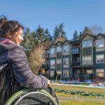 Alt d'image: "Personne en fauteuil roulant recevant une aide financière pour un déménagement facilité à Orléans, illustrant les stratégies d'accessibilité pour les personnes handicapées.